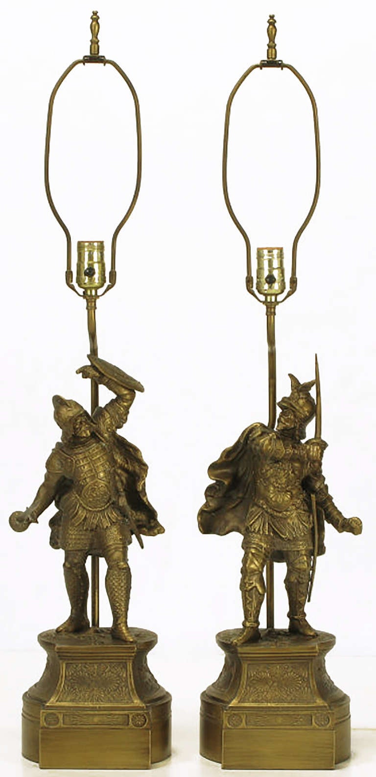 Unexpected pair of cast brass statuettes in the form of Spanish Conquistadors on brass pedestals. Animated forms, with swords, shields and flowing capes. Sold sans shades.