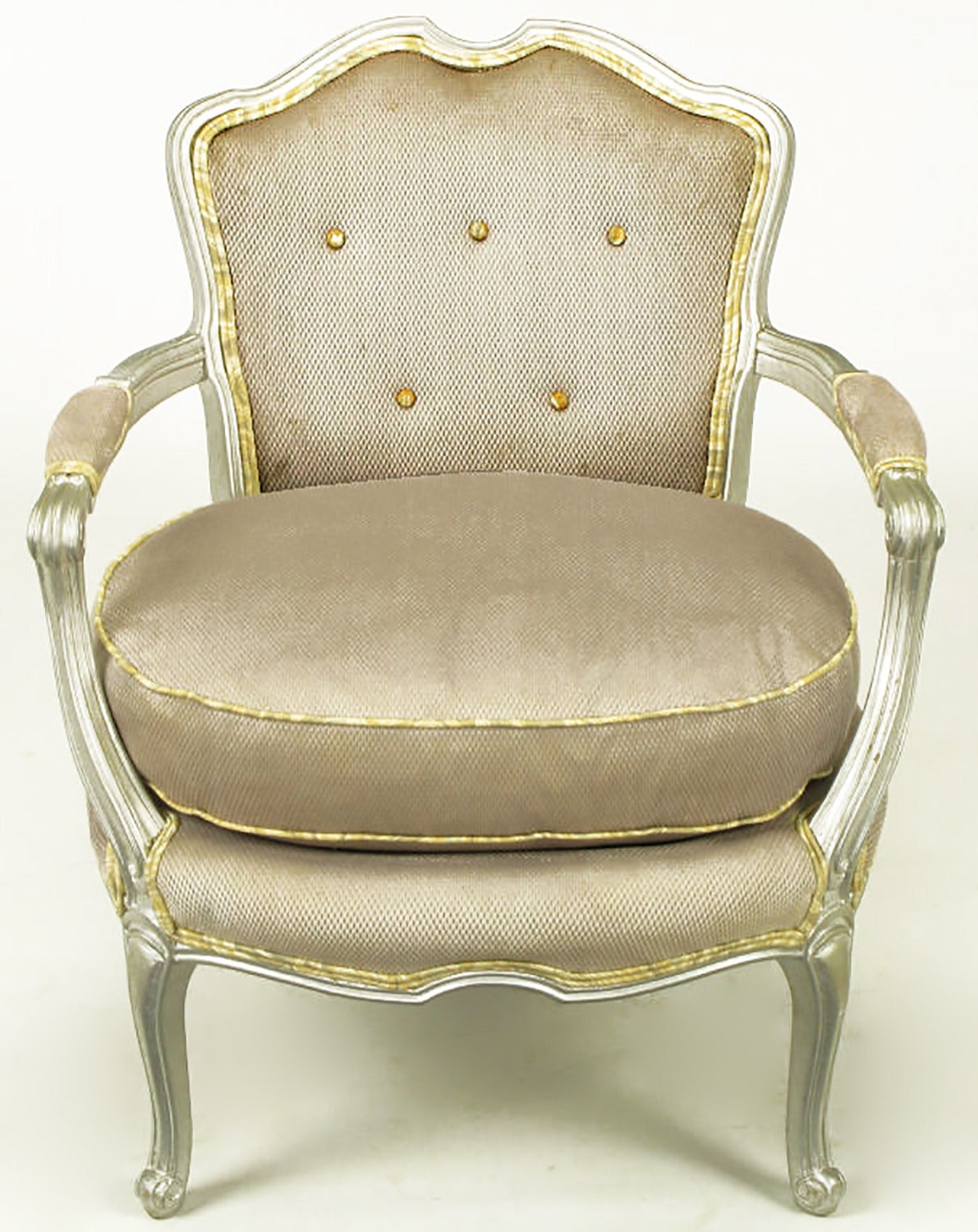 Pair of Louis XV fauteuils with plush seat cushions and button tufted backs in grey piqued velvet with contrasting taupe print velvet welting and buttons. Sliver lacquer over carved wood adds a contemporary touch.