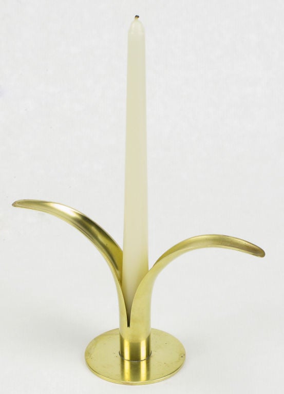 Set of four solid brass candle stick holders in the shape of open leaves of a flower by Ystad Metal of Sweden.