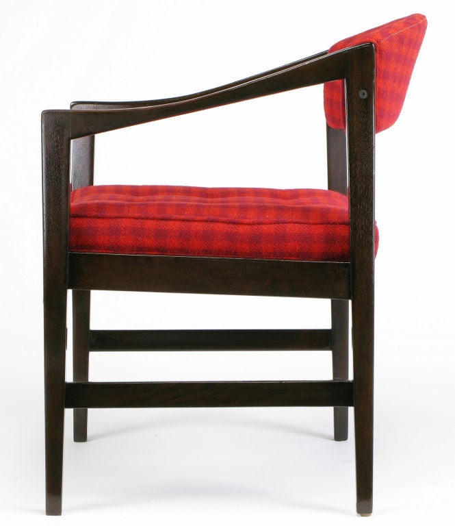 Dunbar walnut arm chair with curved open back, carved and tapered upward rising arms and classic side stretchers. Fixed tufted seat cushion with a top and bottom welt. Appealing crimson and magenta checked wool upholstery believed to be original,