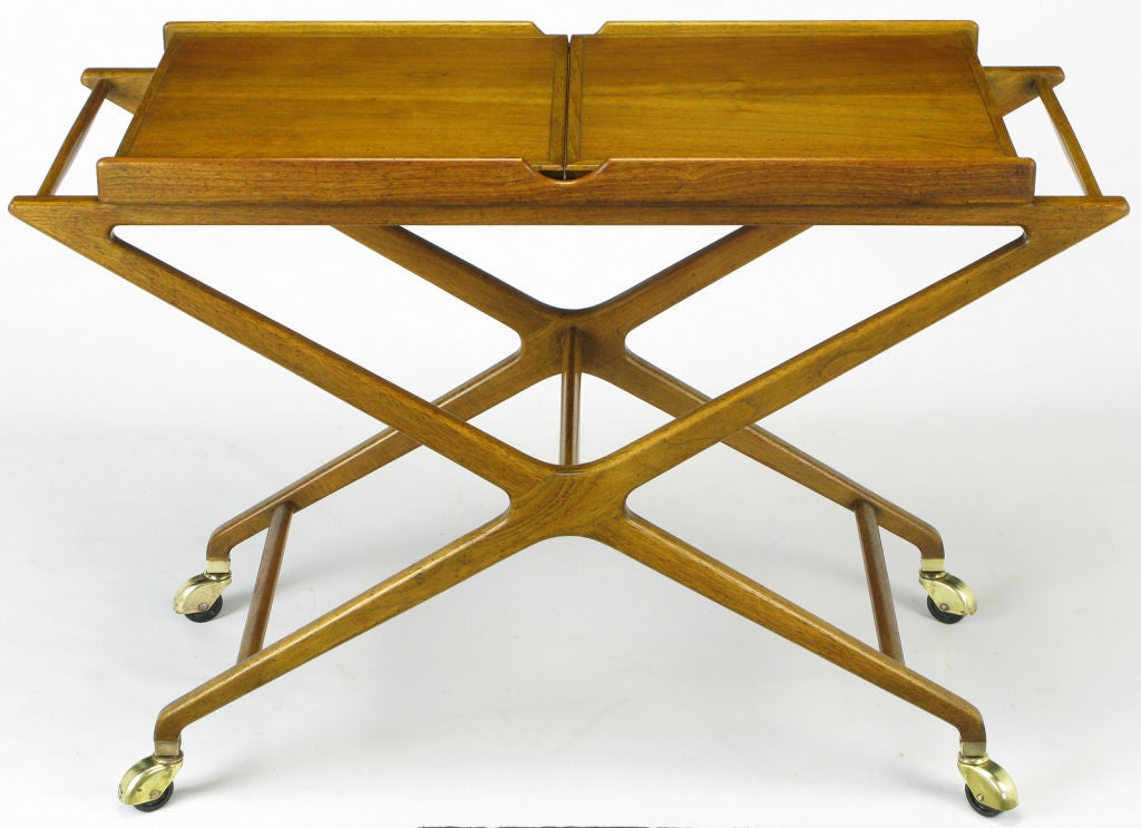 Bleached walnut serving cart with original fendered casters by Michael Taylor Baker Furniture. The three part open service area is covered in white Micarta. The closed top of the server is bleached walnut bordered in bleached mahogany. A very