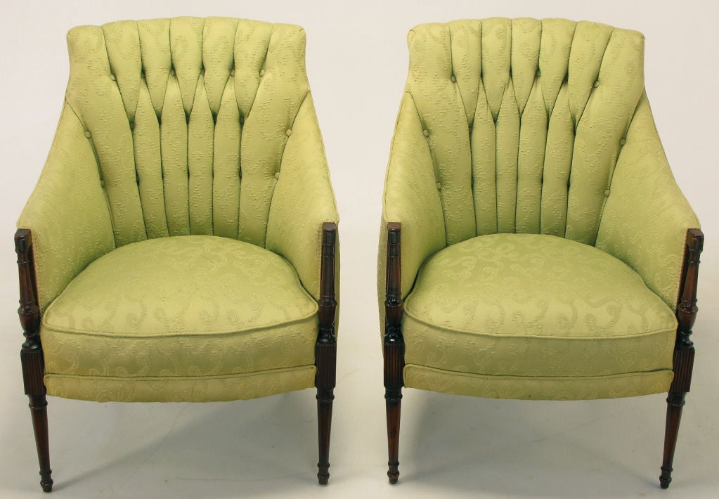 Pair of Regency lounge chairs in original celery damask upholstery. Carved mahogany reeded & baluster form front legs rise up to meet sloped arms. Back legs are a petite saber style, finishing in a fine point. Button tufted and chaneled backs have a