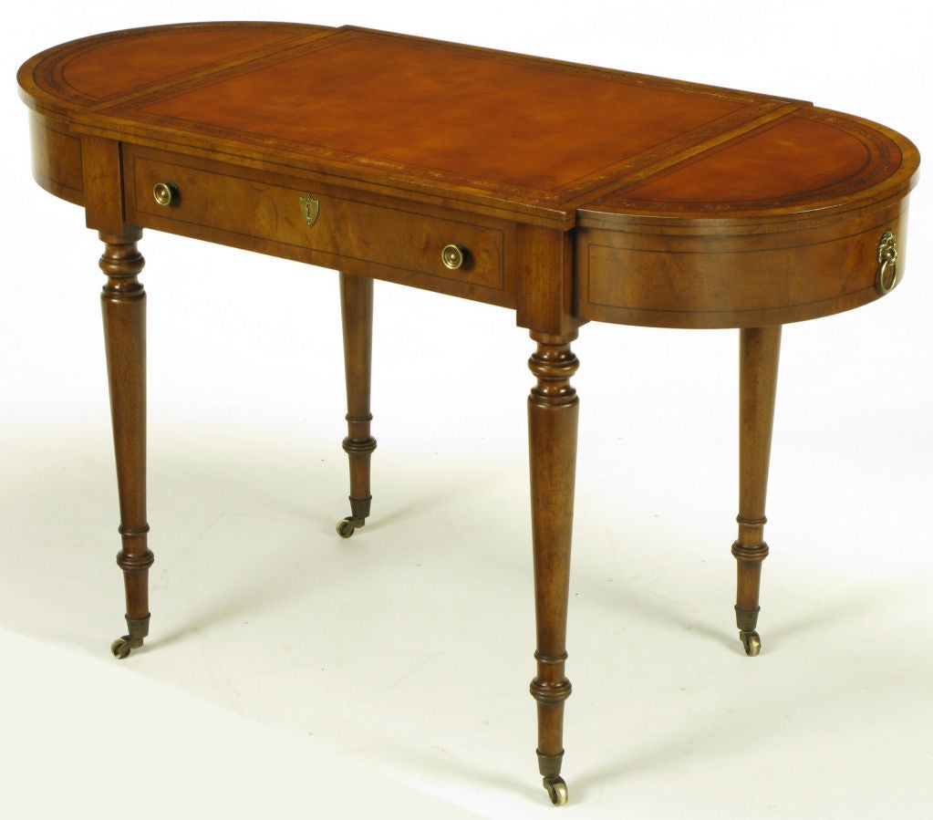 Burled walnut, umber tanned and tooled leather top, oval shaped writing table or petite desk from Old Colony Furniture of Boston, MA. Demilune end section tops are removable, with copper lined planters underneath, that can be used for additional