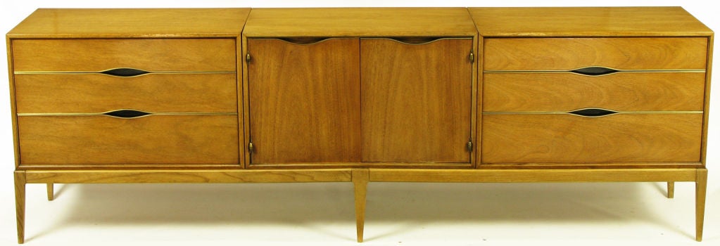 Bleached walnut and brass detailed long dresser by Vignola Furniture, Chicago Il. Modular cabinets are fitted into the six leg base. Drawers open via the black lacquered 