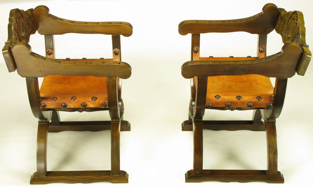 Mid-20th Century Pair Carved Oak & Umber Leather Curule Base Arm Chairs