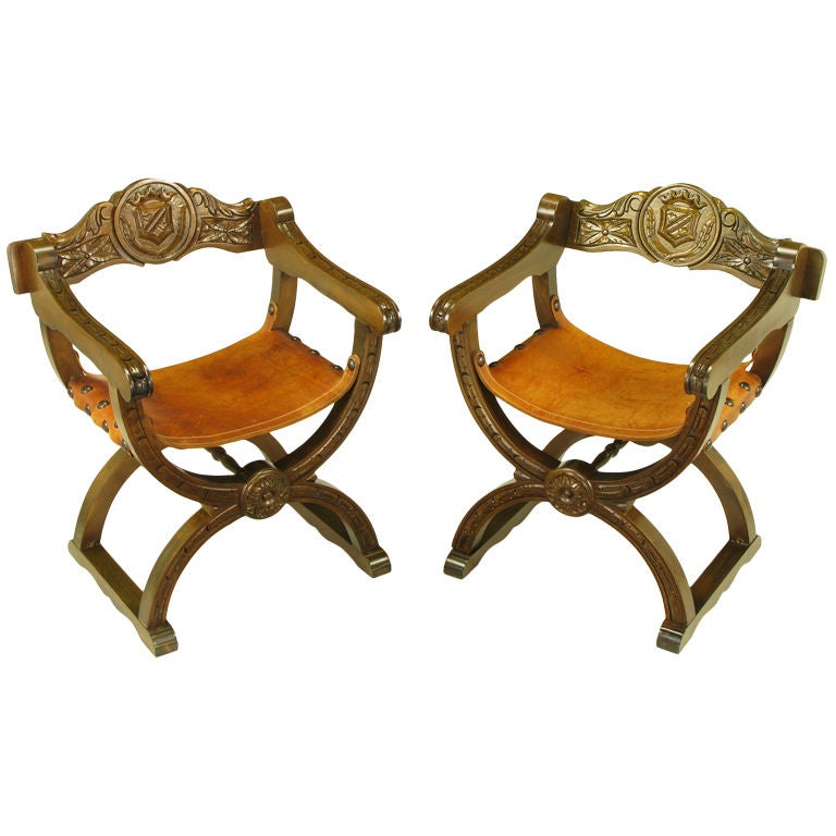 Pair Carved Oak & Umber Leather Curule Base Arm Chairs