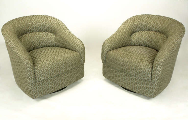 Sleek and sculptural pair of Ward Bennett for Brickel Associates barrel back swiveling club chairs. Covered in newer textured geometric silk and cotton blend upholstery. Taupe, grey and sage green combine to create an interesting but neutral color