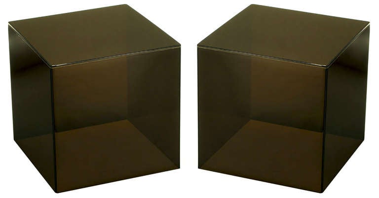 Pair of dark smoked Lucite cube tables. Wonderfully square and recently polished, can be used as a split coffee table or unexpected end tables.