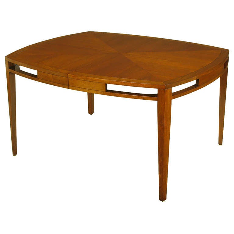 Baker Furniture squared dining table with a radius edge parquetry walnut top and contrasting walnut border. Open end apron with tapered walnut legs. Comes with two leaves that measure 21