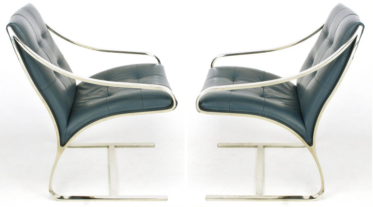 Set of four cantilevered lounge chairs by Bert England for Brueton. Polished steel frames with low slung arms and biscuit tufted cadet blue leather. Can be sold as pairs for 5750.00 per pair.