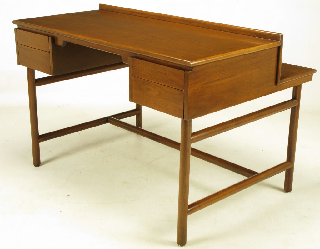 Walnut desk by William Pahlmann with four drawers and front shelf. Unusual base of large intersecting dowels. Restored to outstanding original condition.  From Pahlmann's 1952 Hastings Square Collection for Grand Rapids Bookcase & Chair Company.