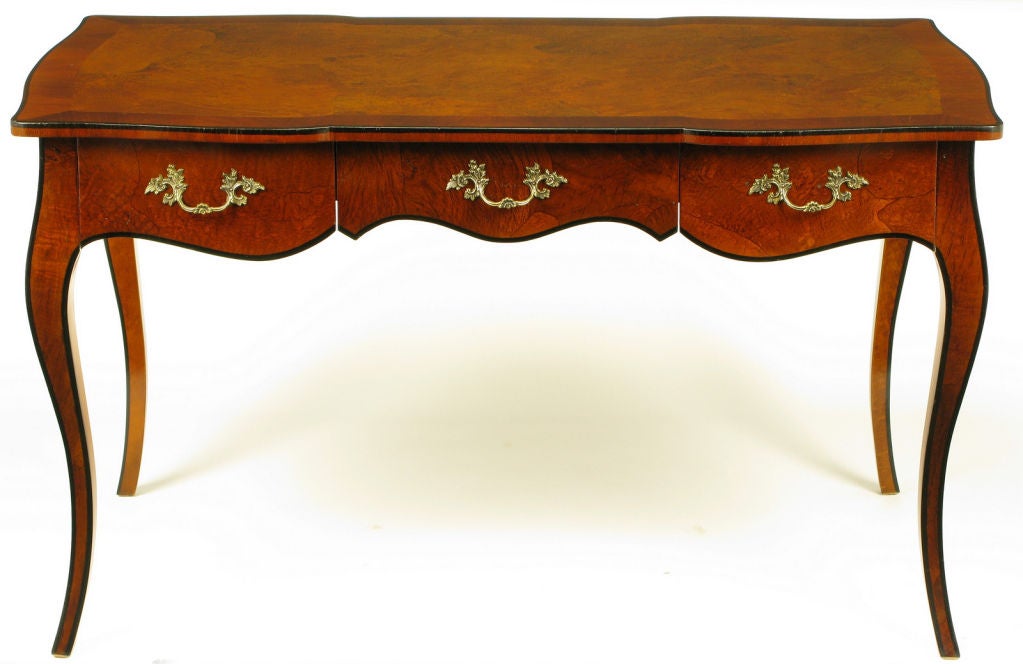 Italian made French regency walnut oyster burl cabriole legged desk with three scalloped bottom drawers and apron. Scalloped edge top bordered in mahogany with black lacquer detailing on the top, legs and apron. Solid brass filigree pulls.