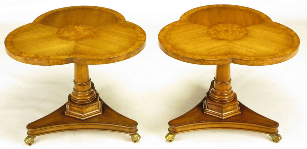 Pair of Regency side/end tables with burled walnut trefoil parquetry tops. Nicely carved solid walnut pedestals on a reverse trefoil base with covered casters. Excellent build quality by Weiman, when it was still located in Rockford, IL, on par with