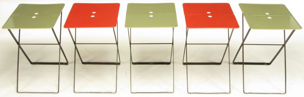 Set of five collapsible metal tables with black lacquered X bases and two part sage and red lacquered tops. Much like the post modern architecturally inspired furniture designs by the Memphis Group. A collective of architects and designers