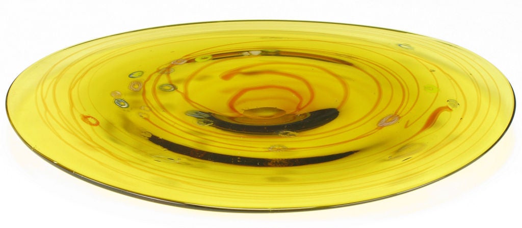 Wide lip Murano glass bowl in hand blown saffron glass with umber ribbon. Blue, green, rose and white ringed controlled bubbles orbit around the center indentation.