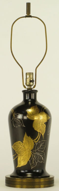 Black porcelain bottle shaped table lamp on pierced brass base. Hand painted and glazed leaves in white and crazed gold leaf. Same quality as vintage Frederick Cooper or Warren Kessler.