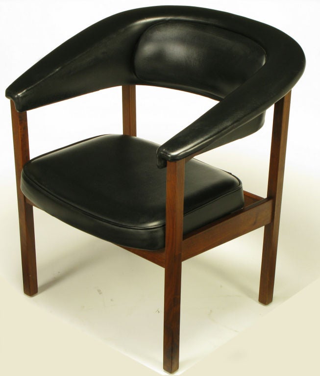 Walnut frame and very heavy black vinyl upholstered desk chair with a rolled arm barrel back and cantilevered seat. Comfortable and striking desk chair.