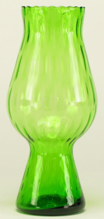 Kelly green ribbed glass footed vase. Scalloped top edge and tactile conical footed base.