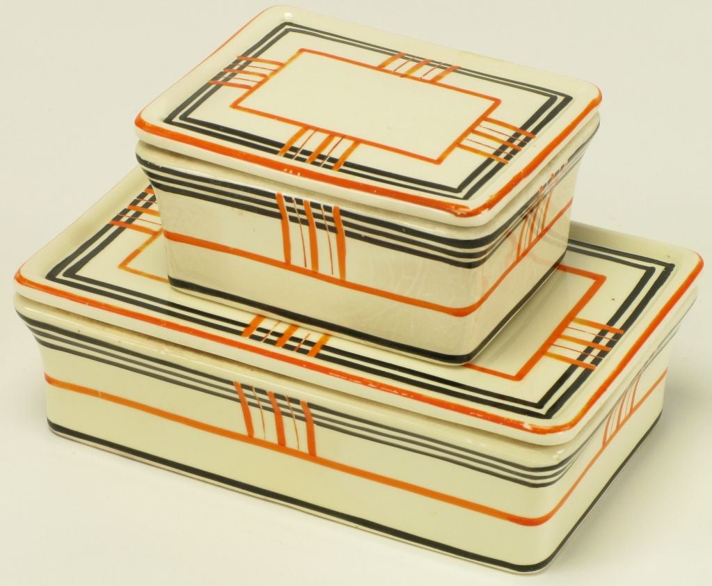 Set of Japanese porcelain boxes with removable lids. Hand thrown and glazed in white with orange and brown geometric striping.