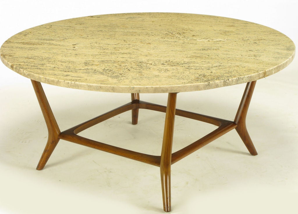 Bertha Schaefer for M. Singer and Sons carved walnut and travertine top saber leg coffee table. Squared sculptural base juxtaposes with the round travertine top creating an intriguing and rare coffee table by the same company that worked closely