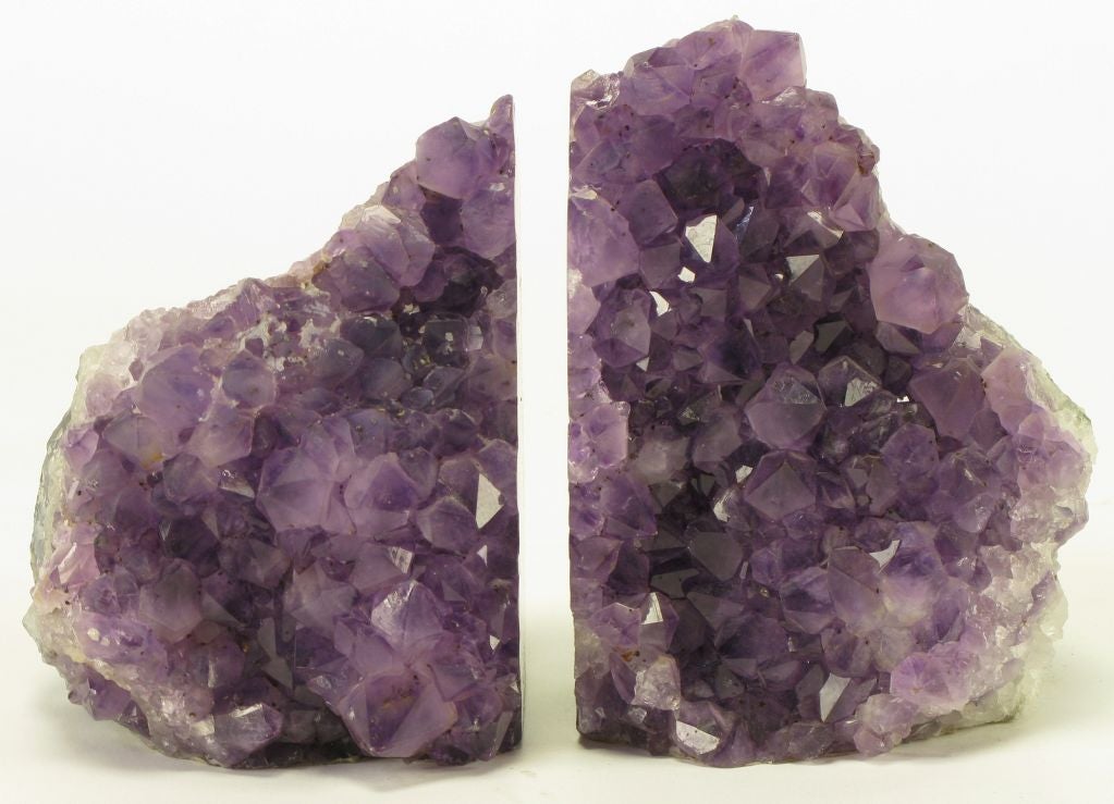 Stone bookends in amethyst crystal, clear crystal, and a small amount of jade green minerals.