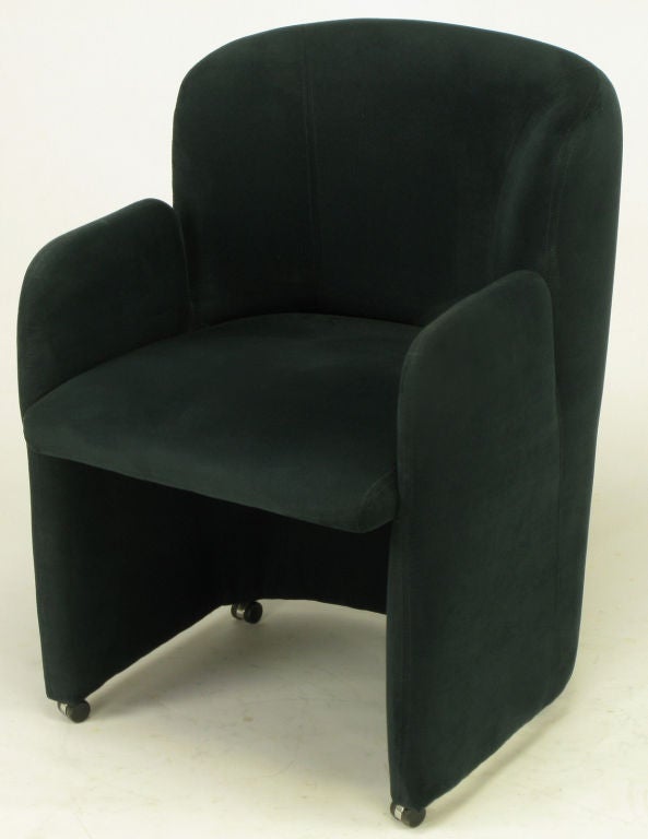Barrel back arm chair in black suede from Preview Furniture. Vladimir Kagan designed several lines for Preview, a division of Wieman Furniture, Hickory North Carolina. Sculpted arms and back with slight overhang to seat. Four casters for ease of