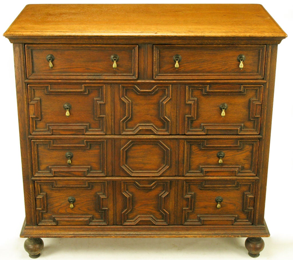 Tobacco oak Jacobean style carved front five drawer cabinet with cast solid brass tear drop pulls. Recessed double panel sides and beveled molding base with ball front feet. Manufactured by the Charlotte Furniture Company, Charlotte Michigan,