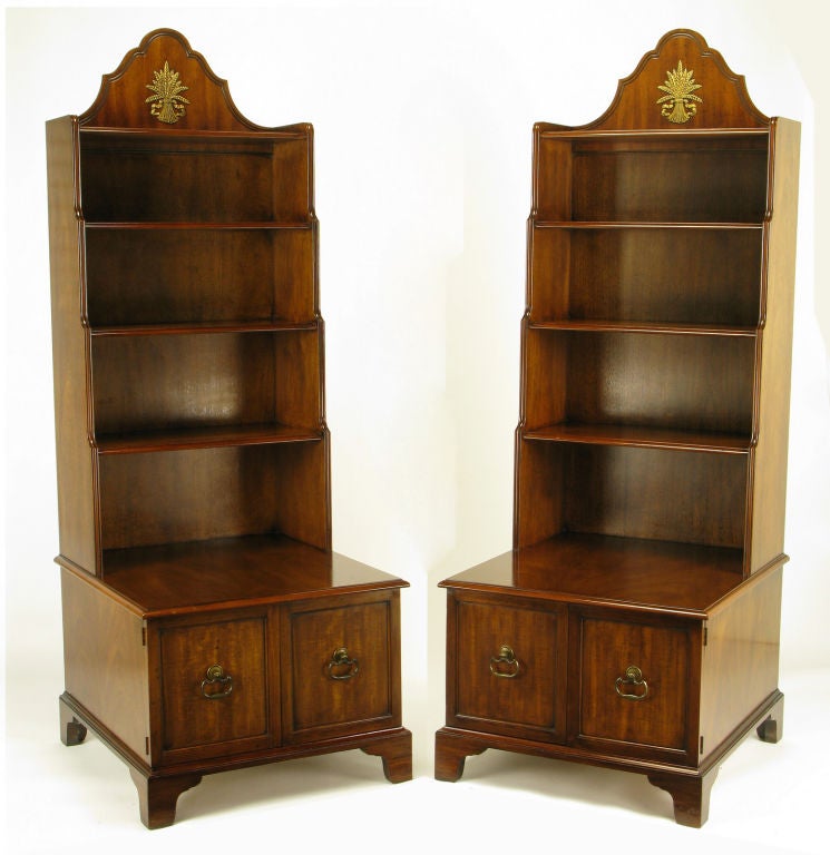 Uncommon pair of tall mahogany bookshelf nightstands from the Tidewater Collection by Morganton. Bracketed style feet support the deep two door cabinet with solid brass drop ring pulls and round escutcheons. Book case tops have brass sheaves of
