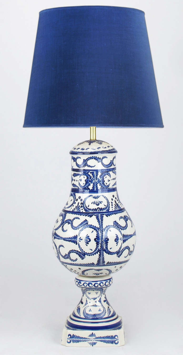 Nearly four feet in height, this white and blue glazed pottery table lamp has an impressive presence. The ceramic body was made by Noe Suro, a Mexican artist renowned for his pottery work. Shade not for sale. Similar shade can be ordered.