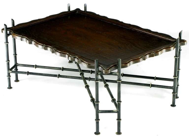 Hand wrought iron, brass and dark ash wood Chinese Chippendale coffee table. The iron base is finished in a patinated black lacquer with brass rings creating the stylized bamboo effect . The scalloped edge top is ash wood, stained dark mission brown