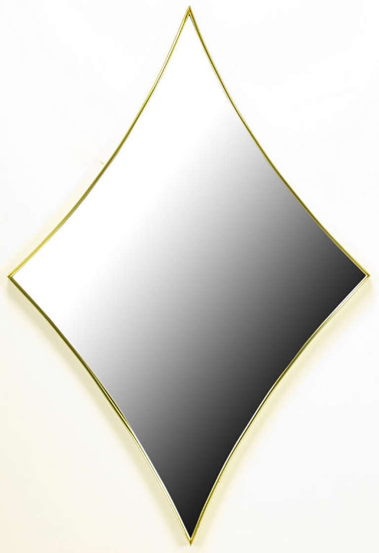 Elegant and clean lined arc-edge rhombus mirror framed in a simple, thin beveled brass frame.