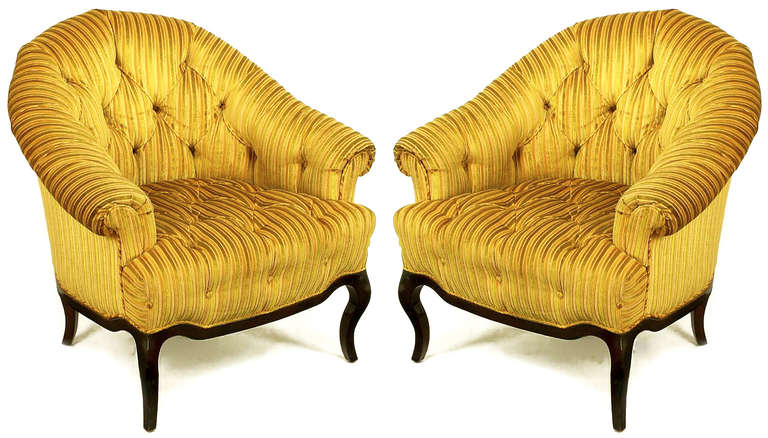 Pair of button tufted, cut and striped gold velvet lounge chairs with rolled sloping arms and barrel back by Interior Crafts, Chicago custom furniture manufacturer to the trade. Carved walnut cabriole legs with scalloped walnut apron. Among others,