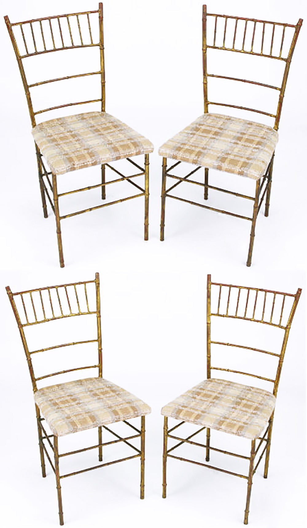 Set of four Chiavari style distressed gilt metal dining chairs in stylized bamboo with upholstered seats. Seat covered with cross hatch textured cotton in tan, brown and light blue.