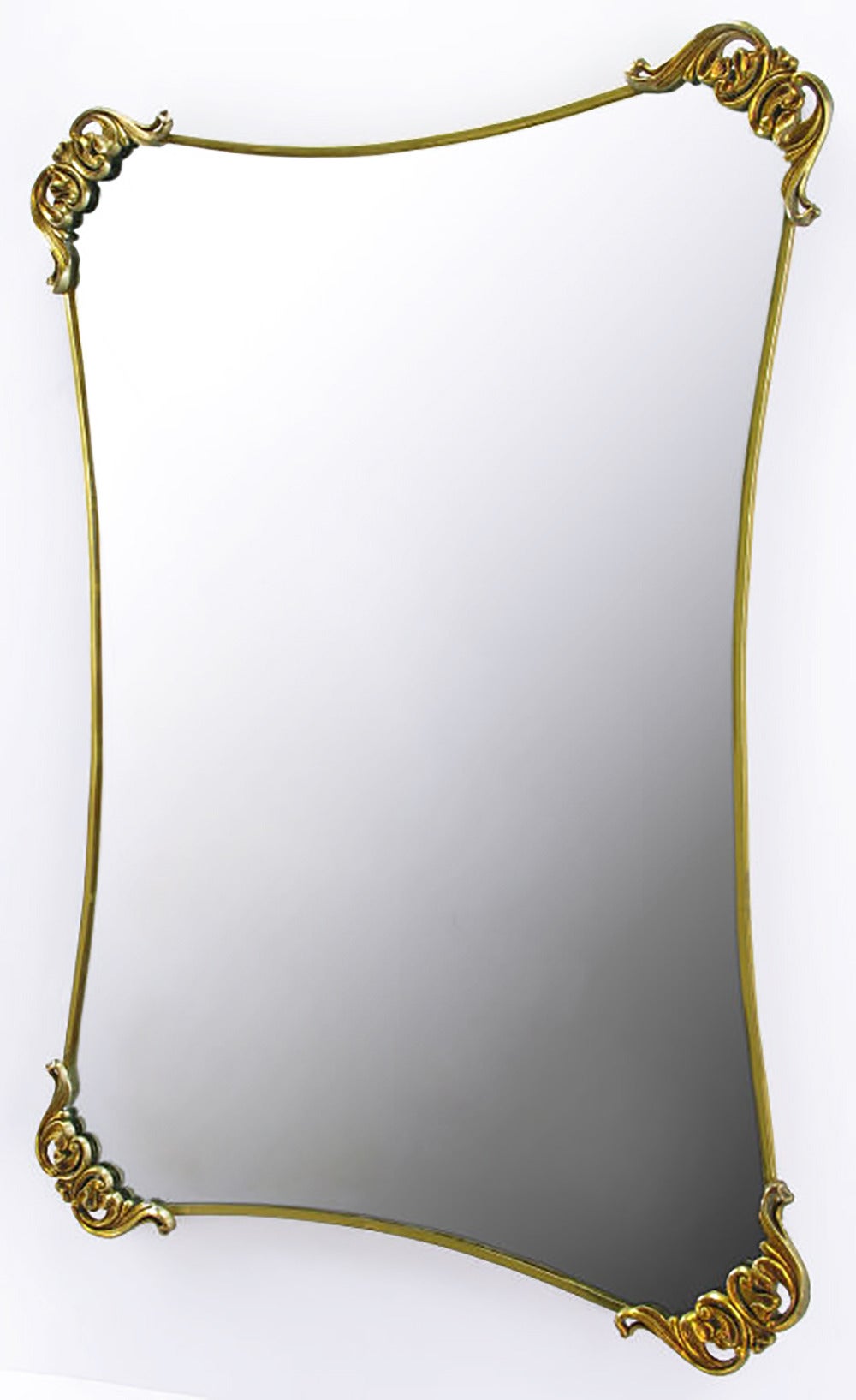 Elliptically indented Regency mirror, framed in brass-plated metal. Radiused corners are adorned with filigreed brass appointments. Can be hung horizontally or vertically.