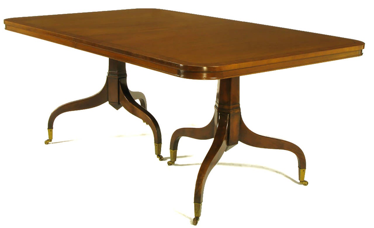 Kittinger of buffalo, NY mahogany dining table with radiused corners and an incised top border. A modern derivation of the Georgian style, double pedestal bases with 