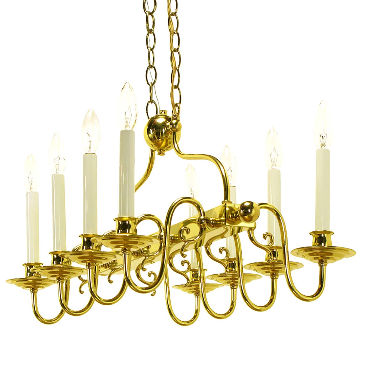 Elegant brass rectangular eight-arm chandelier with side finials on the brass bar center and eight sinuous arms. Double row of chain with center brass ball connector and rectangular canopy. Perfect for an elegant kitchen island as well as
