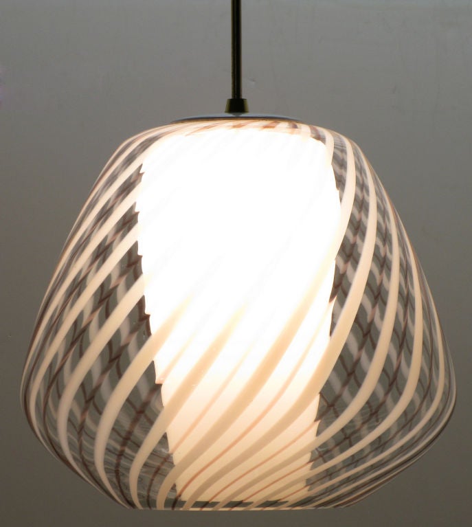 Exquisite Lightolier large pendant light. Hand blown Murano glass globe with clear, white and pink glass swirled striping. Conical internal milk glass diffuser with brass stem and canopy