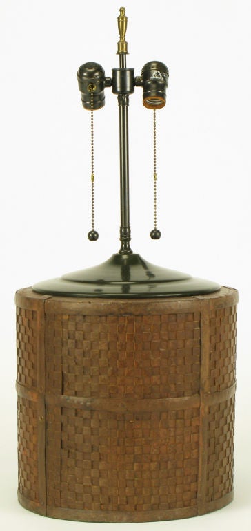 Excellent patina and age on this twelve inch diameter Chinese inspired  table lamp from Chicago's Lang Levin Studios. Bamboo reed like basket with large dark chocolate lacquered  stepped brass cap and dual socket illumination. Exceptional quality,