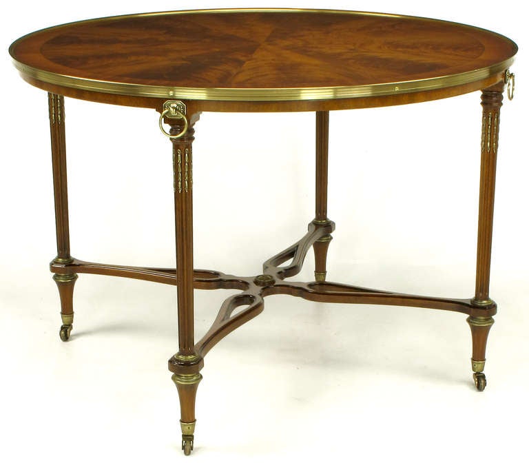 John Widdicomb Company Regency center table with crotch mahogany parquetry top with brass gallery, brass appointments and pierced X-stretcher with center rosette. Incredible wood grained top, ribbon mahogany banded apron, solid mahogany fluted legs