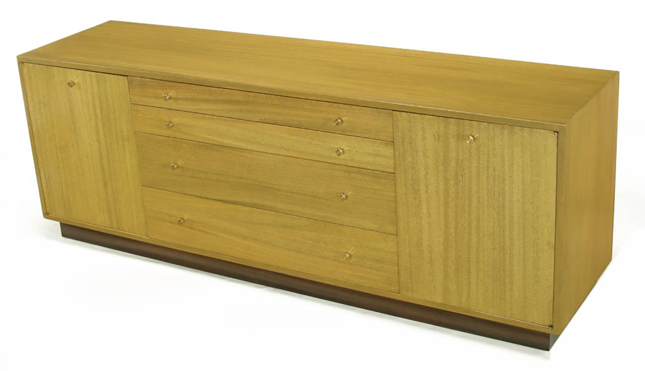 Harvey Probber long, low credenza or sideboard with four ascending height drawers and pair of shelved cabinets measuring 16.5
