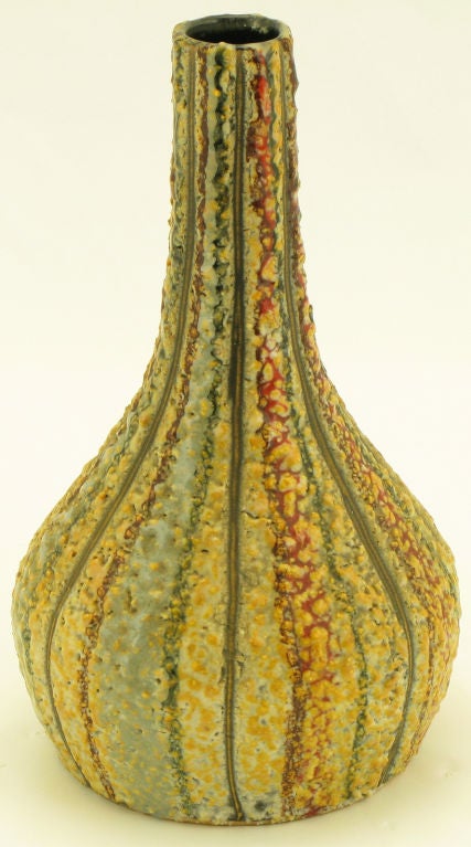 Unique Italian drip glazed hand thrown earthen pottery vase. Incised pattern of red, blue, grey and white running top to bottom with a saffron over lay speckle glaze. Signed and numbered, possibly marketed through Raymor.