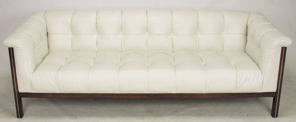 Rarely seen or offered, ostrich pattern white vinyl covered button tufted sofa designed by Bert England for Interior Crafts, Chicago IL. Fixed seat cushion with rolled back and arms. Mahogany frame with inlaid brushed aluminum detail to the front