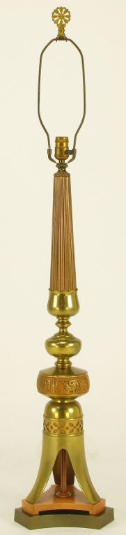 Tall Japanese table lamp comprised of carved and lacquered wood, stamped and lacquered brass with a pierced and backed open tripodal footed base. Mounted on a reverse trefoil two part plinth.<br />
<br />
marked inside the brass base - 