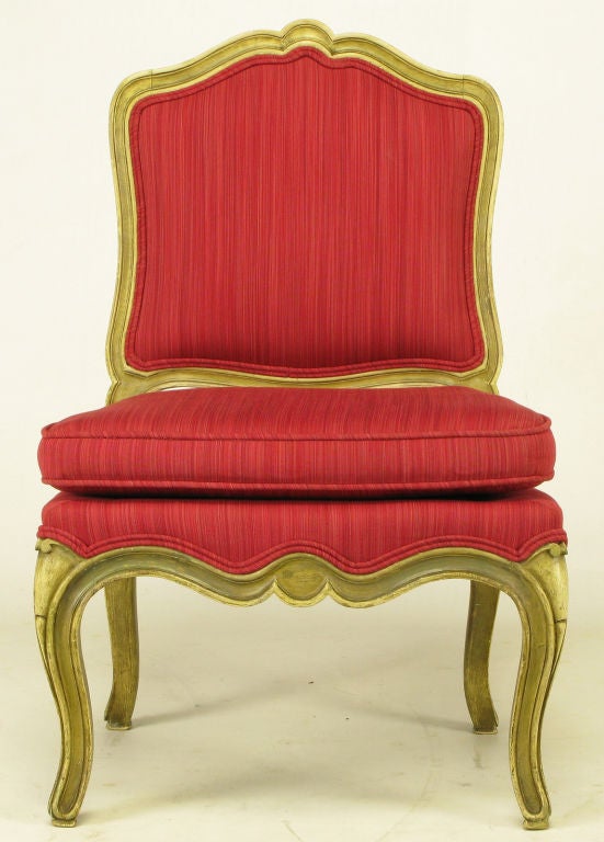 Queen Anne style child's chair in carved wood and aged ivory lacquer. Upholstered in a tactile striped crimson silk. Frame has natural aged ivory lacquer with equally aged gilt accents. Cabriole front and rear legs.