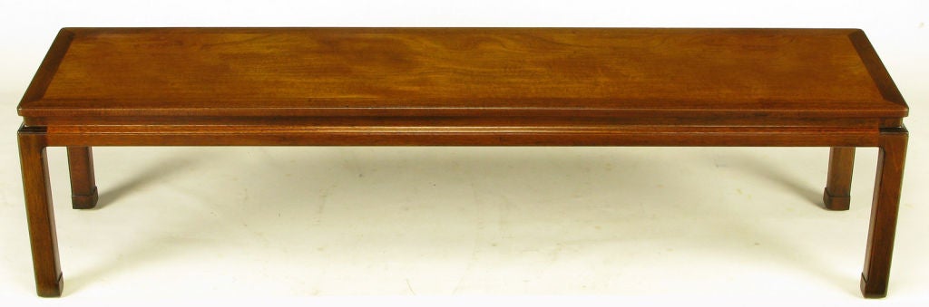 Edward Wormley Chinoiserie style coffee table number 4526 in dual tone mahogany wood. Ming-inspired legs and recessed apron. Top is bordered in a contrasting grained and toned mahogany. Would also work well as a long narrow bench.