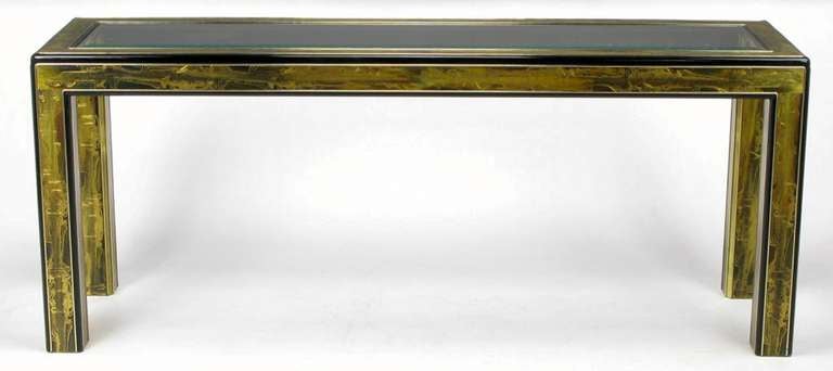 Acid etched panels by noted metal artist Bernhard Rohne cover nearly every flat surface of this black lacquered, radius edged parsons console table from Mastercraft. Beveled center glass panel top.

For best price, call us directly.