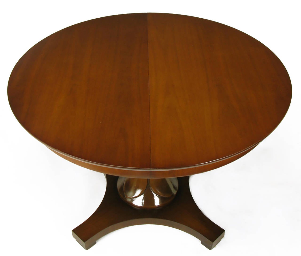 Walnut pedestal dining table with reverse quatrefoil base, designed by Lorin Jackson & Lee Stone for Drexel. Jackson is best known for his designs for Grosfeld House. Hour glass shaped pedestal with center ring and flower petal carved upper and