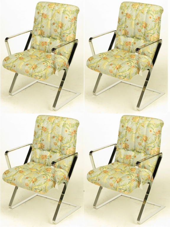 Set of four cantilevered, Z frame, chromed flat bar steel dining arm chairs. Original channeled and button tufted print silk blend upholstery with rolled top seat backs. Quality and style similar to designs from Brueton and Milo Baughman. <br