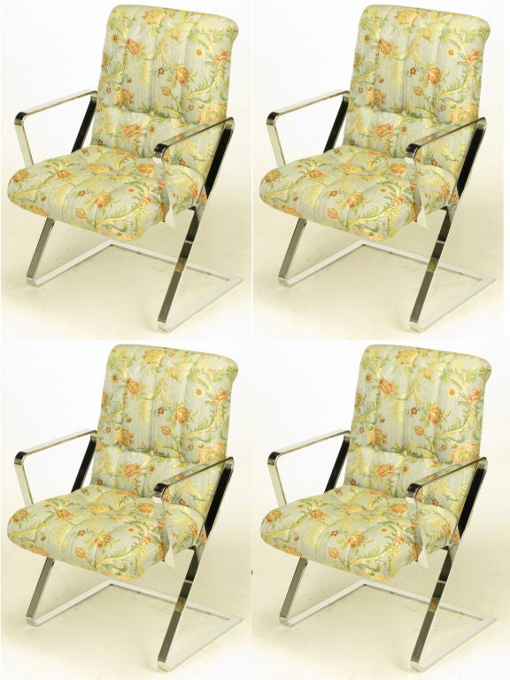 Set of four cantilevered, Z frame, chromed flat bar steel dining arm chairs. Original channeled and button tufted print silk blend upholstery with rolled top seat backs. Quality and style similar to designs from Brueton and Milo Baughman. <br