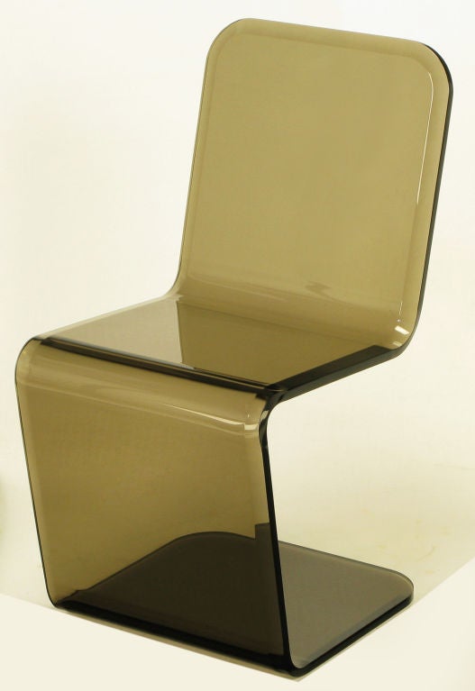Superlative design and use of material, smoked lucite cantilevered single chair. Beveled edge on single piece of bent  acrylic with radiused corners, recently polished to perfection.